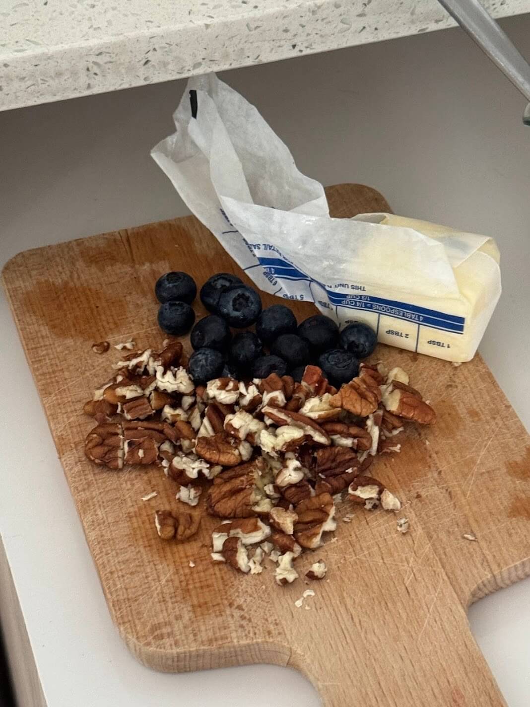 Ingredients like blueberries, pecans, and butter sit on a wooden cutting board as a podcast launch checklist metaphor.